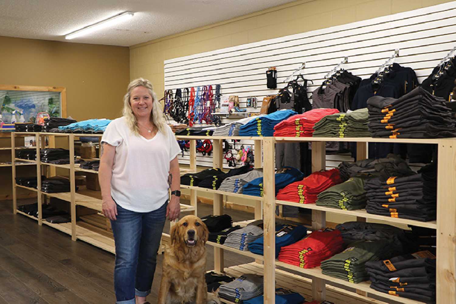 Shauna Cutler in her new store, Hutt’n Doggie Do’s Work Wear and More, along with Charlie.
